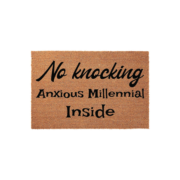 Anxious Millennial No Knocking Doormat featuring a natural coir fiber texture with bold black text that reads No knocking Anxious Millennial Inside, creating a humorous and relatable entryway decor piece for any apartment or home