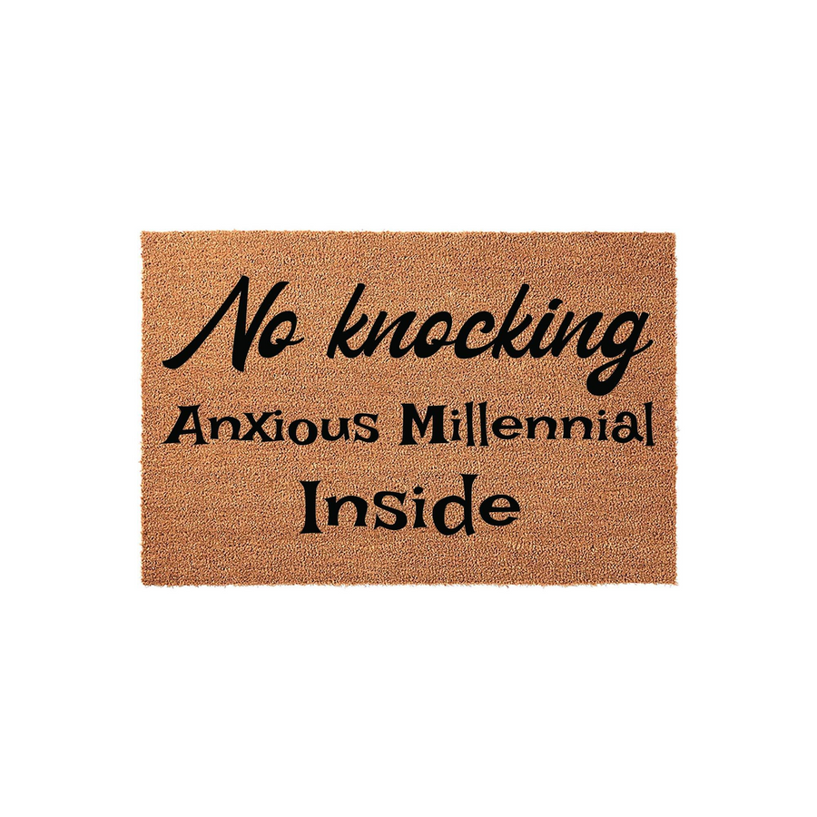 Anxious Millennial No Knocking Doormat featuring a natural coir fiber texture with bold black text that reads No knocking Anxious Millennial Inside, creating a humorous and relatable entryway decor piece for any apartment or home