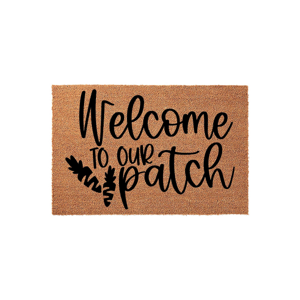 Welcome to our patch coir doormat featuring a natural brown fiber texture and bold black script lettering, accented with a cute carrot illustration to create a festive spring or Easter entryway decor piece for your front porch.