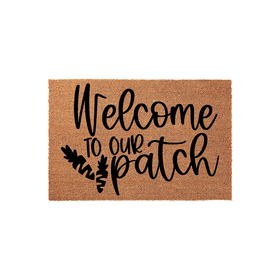 Welcome to our patch coir doormat featuring a natural brown fiber texture and bold black script lettering, accented with a cute carrot illustration to create a festive spring or Easter entryway decor piece for your front porch.