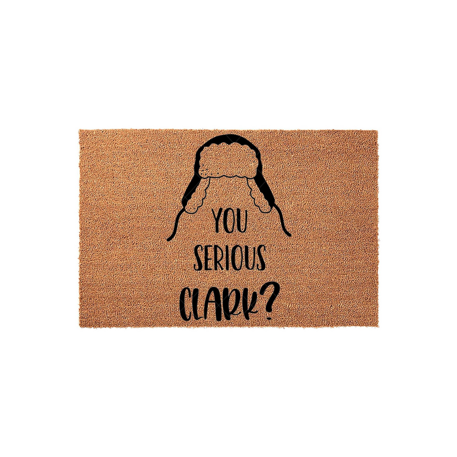 Funny Christmas doormat featuring a black graphic of a trapper hat and the text You Serious Clark, printed on a natural brown coir fiber mat that adds a festive and humorous touch to your holiday home entryway decor.