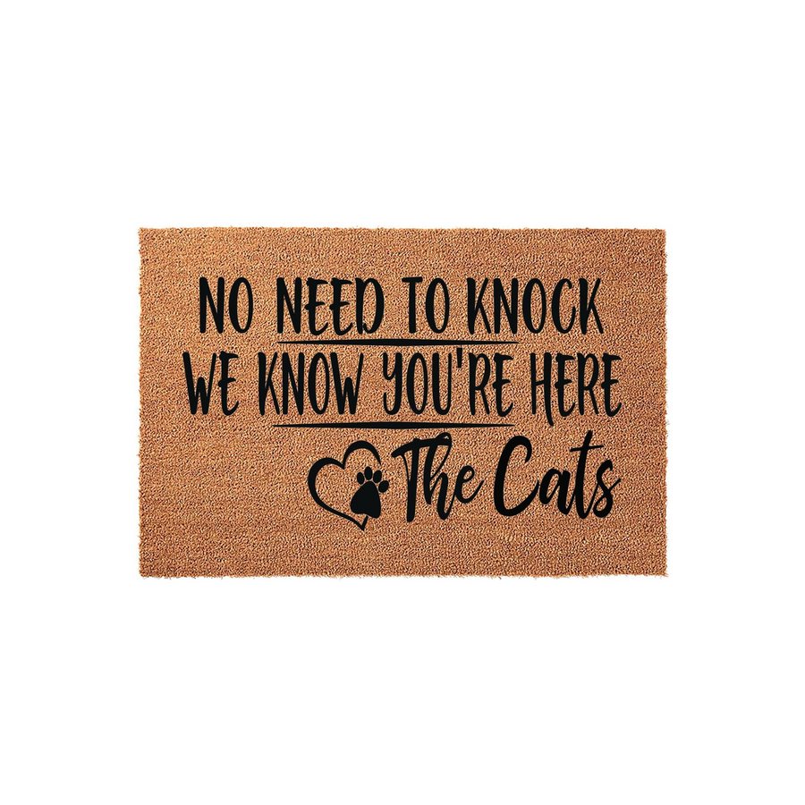 Funny Cat Lover Doormat featuring a natural coir texture with black text that reads No Need To Knock We Know You Are Here The Cats, accented by a heart and paw print design for a charming entryway decor piece for any feline