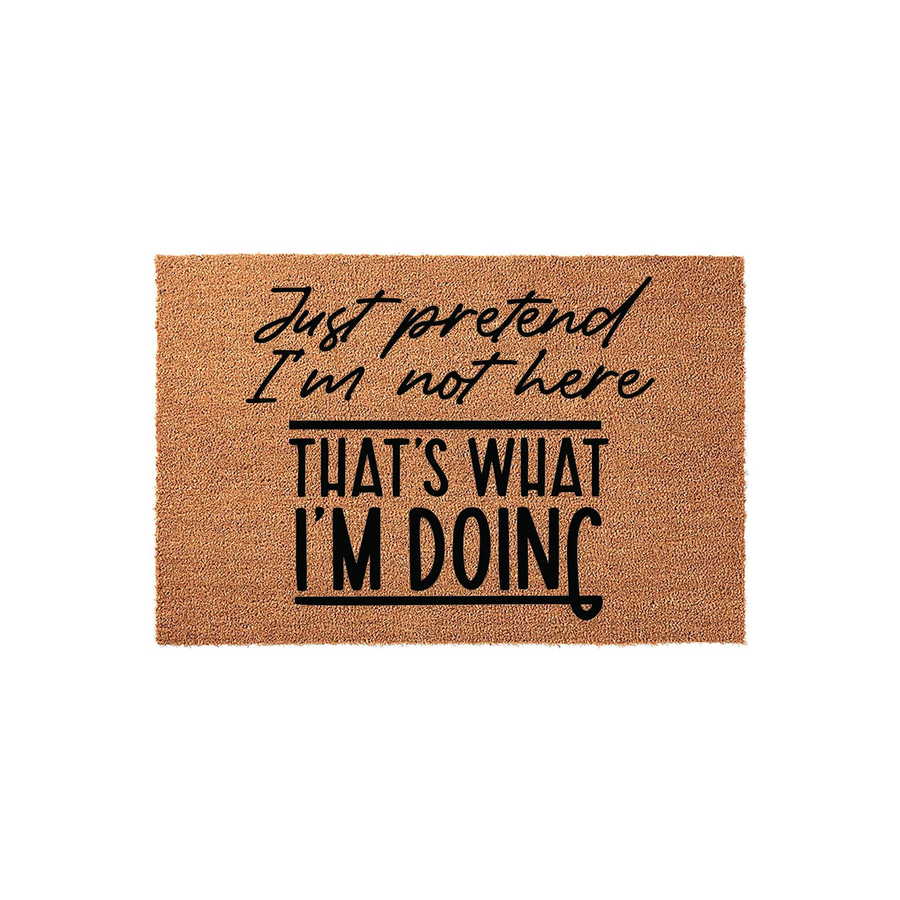 Funny Just Pretend I Am Not Here doormat featuring bold black text on a natural coir fiber background, designed as a humorous front porch welcome mat for guests that adds a touch of personality to your home entryway decor.
