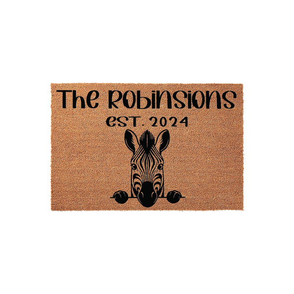 Personalized Zebra Coir Doormat featuring a cute black and white zebra illustration peeking over the bottom edge, with custom family name text and established year printed in bold black lettering on a natural brown fiber