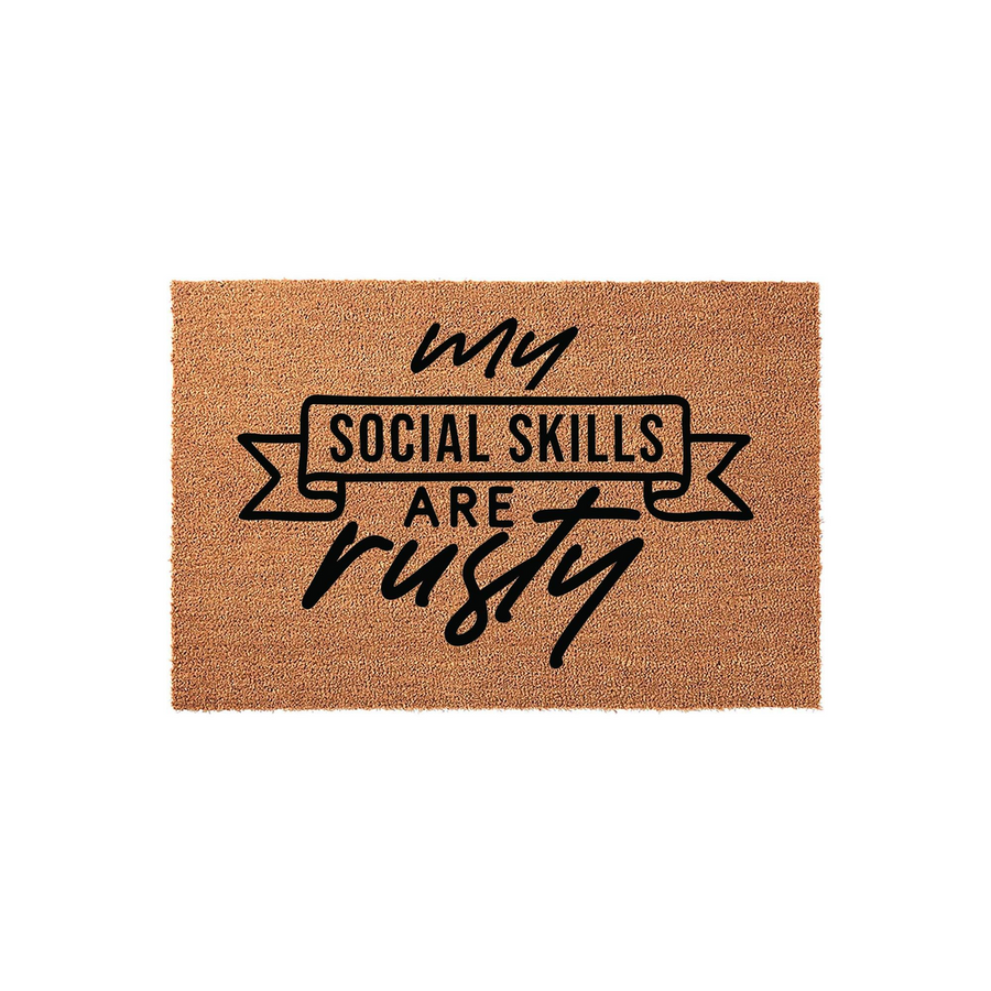 Funny My Social Skills Are Rusty coir doormat featuring a natural brown fiber texture and bold black typography, designed as a humorous front porch welcome mat for guests with a witty sense of humor about social interactions.