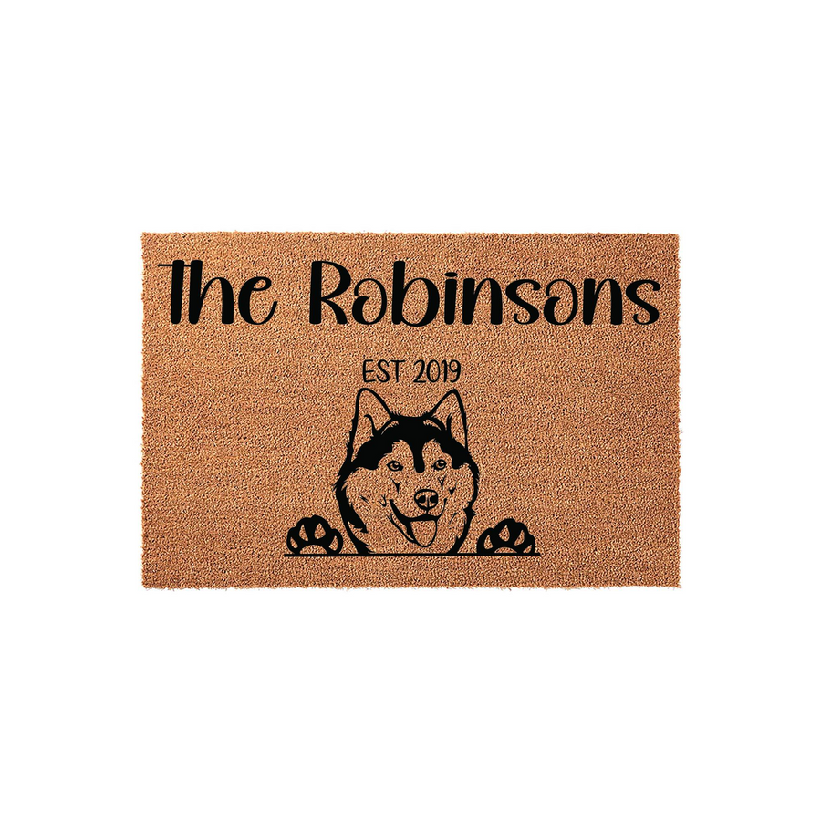 Personalized Husky dog doormat featuring a cute illustration of a Siberian Husky peeking over the edge with its paws, customized with a family name and established year on a natural coir fiber background for a welcoming home