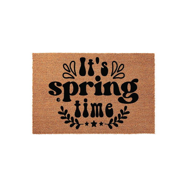 Springtime coir doormat featuring a natural tan fiber texture and bold black lettering that reads It's spring time, accented with decorative leaves and stars in a clean, modern design suitable for a front porch entryway.