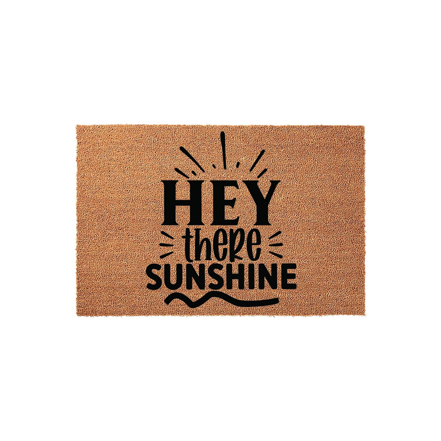 Hey There Sunshine coir doormat featuring a natural brown fiber texture and bold black typography with sunburst accents, creating a cheerful and welcoming entrance decor piece for your front porch or home entryway.