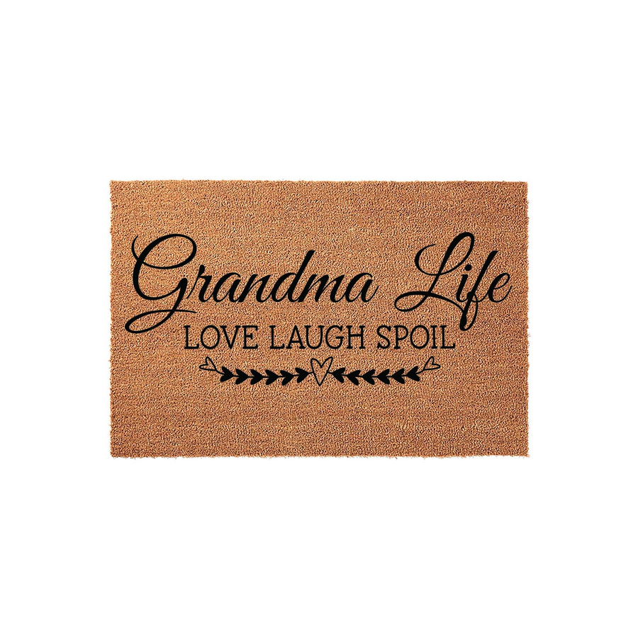 Grandma Life coir doormat featuring a natural tan fiber texture with black printed text that reads Grandma Life Love Laugh Spoil, accented by a decorative heart and arrow design on a clean white studio background for a front