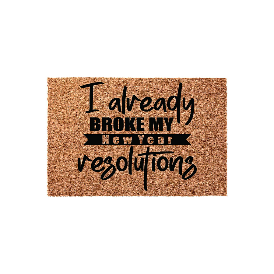 Funny New Year resolution coir doormat featuring a natural tan fiber texture and bold black typography that reads I already broke my New Year resolutions, making it a humorous front porch decor piece for the holiday season.