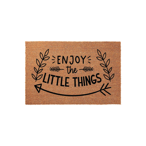 Enjoy the Little Things coir doormat featuring a natural brown fiber texture and black printed text, framed by decorative leaf branches and a stylized arrow design on a clean, plain white studio background for a modern entryway.