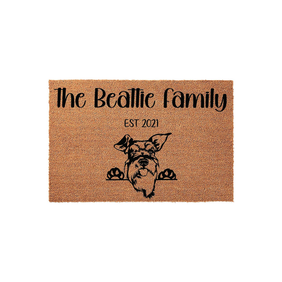 Personalized Schnauzer family doormat featuring a natural coir texture with a black printed illustration of a Schnauzer dog peeking over the edge, customized with a family name and established year on a clean white background.