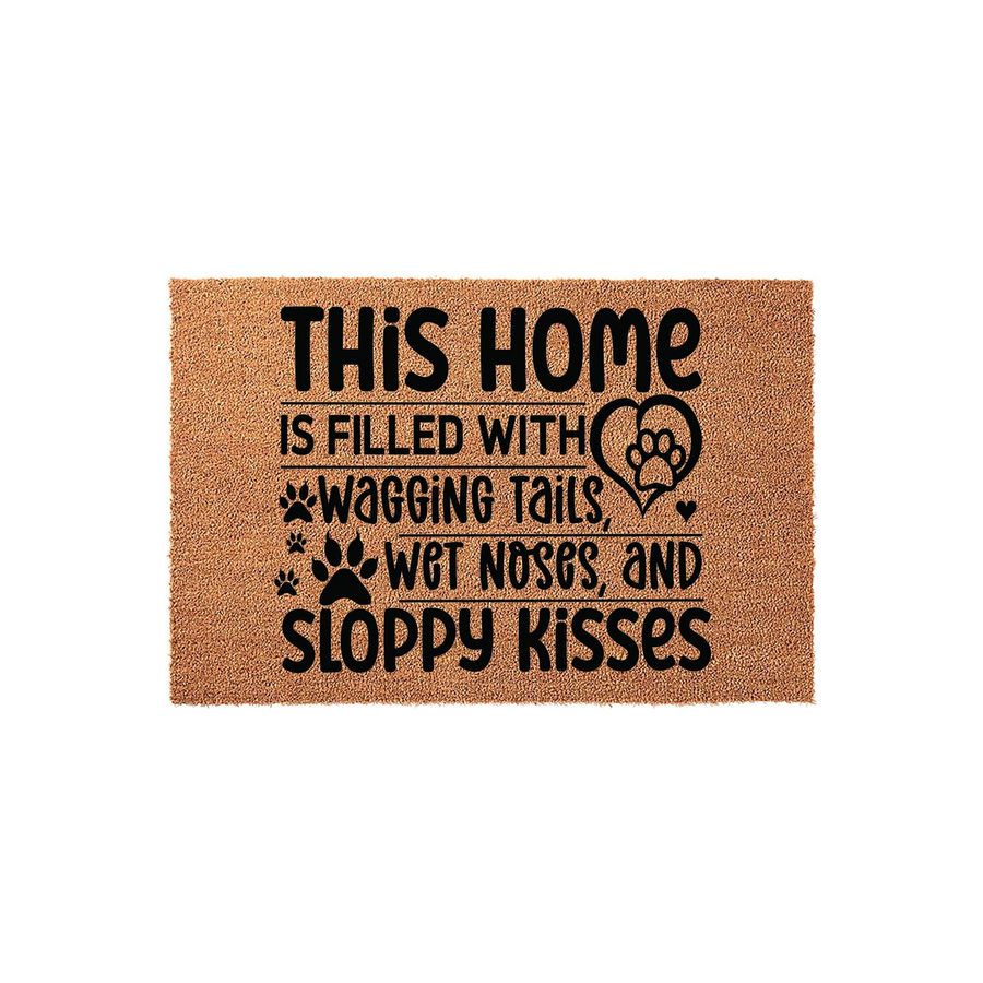 Dog lover coir doormat featuring the text This home is filled with wagging tails, wet noses, and sloppy kisses in black lettering, accented with paw prints and a heart shape on a natural brown textured fiber background for a pet