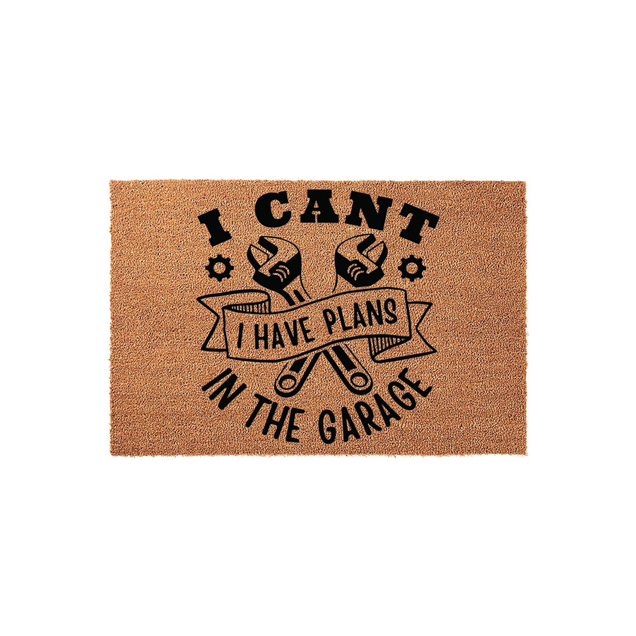 I Cant I Have Plans In The Garage doormat featuring a natural coir texture with black printed text and crossed wrench graphics, making it a fun and functional outdoor welcome mat for any mechanic or DIY enthusiast's home entrance.