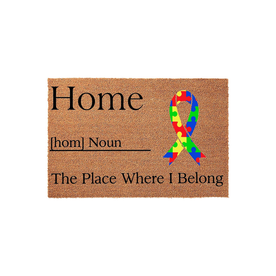 Autism Awareness Home Doormat featuring a natural coir texture with black text that defines home as the place where I belong, accented by a colorful puzzle piece ribbon graphic to show support for neurodiversity at your front
