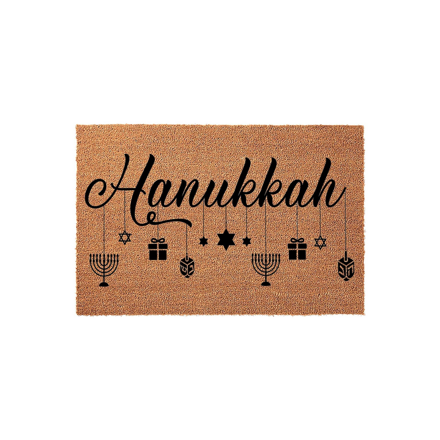 Hanukkah coir doormat featuring the word Hanukkah in elegant black script, accented by hanging icons of menorahs, dreidels, gift boxes, and Stars of David on a natural brown fiber background for a festive holiday entryway decor.
