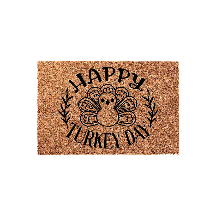 Happy Turkey Day coir doormat featuring a central illustration of a cute turkey surrounded by a decorative leaf wreath, printed in bold black ink on a natural tan fiber background for a festive Thanksgiving entryway decor style.