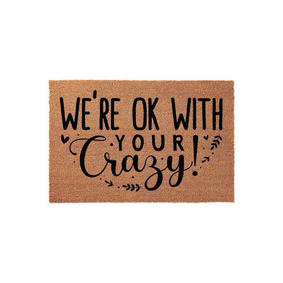 Funny Welcome Doormat featuring the text We are ok with your crazy in bold black lettering on a natural tan coir fiber background, creating a humorous and inviting entryway decor piece for your front porch or home entrance.