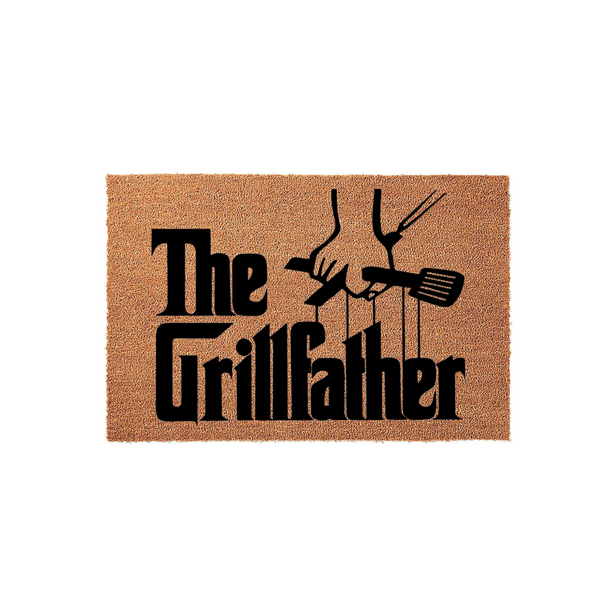 The Grillfather coir doormat features a humorous black graphic of hands holding a spatula and tongs, making it a fun outdoor welcome mat for any dad or grandpa who loves cooking on the backyard barbecue grill during the summer