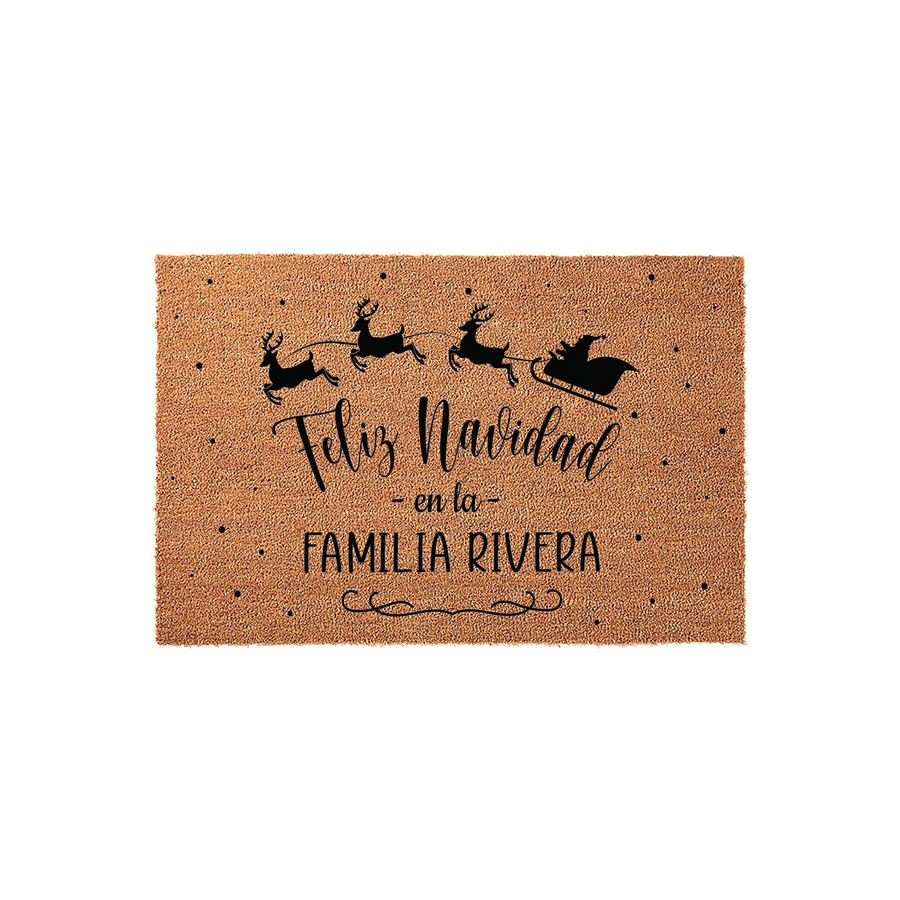 Personalized Feliz Navidad Christmas doormat made of natural coir fiber, featuring a black silhouette of Santa and his reindeer flying above the festive Spanish holiday greeting and a customizable family name on a plain white