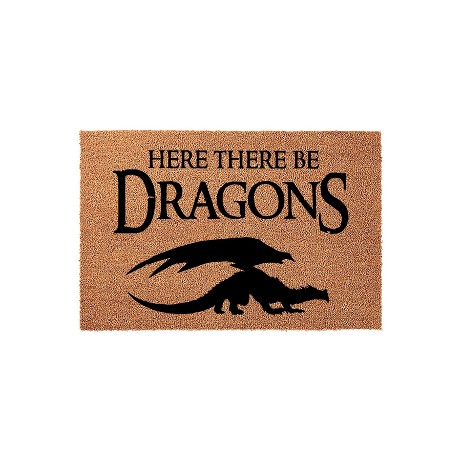 Here There Be Dragons coir doormat featuring a bold black silhouette of a dragon and fantasy-themed text printed on a natural tan fiber background, making it a fun and unique entryway decor piece for any home or apartment front