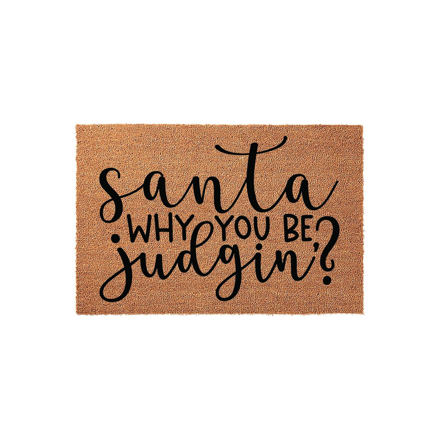 Funny Santa Why You Be Judgin? doormat featuring a natural coir texture and bold black script lettering, making it a humorous holiday front porch decor piece for your home entrance during the festive Christmas season.