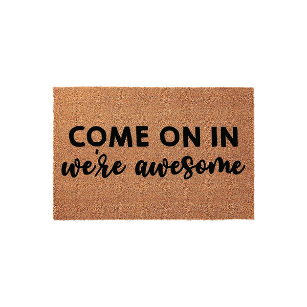 Funny Welcome Doormat featuring the text Come On In We Are Awesome in a mix of bold block and script fonts, displayed on a natural brown coir fiber mat against a clean white background for a modern and inviting front porch
