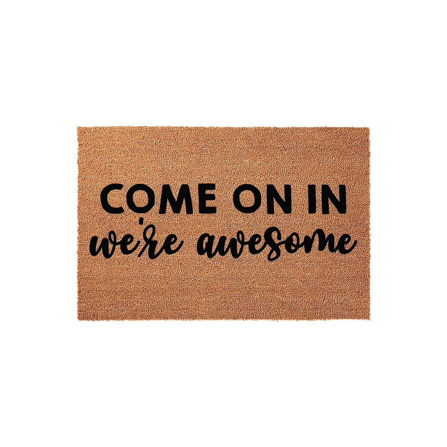 Funny Welcome Doormat featuring the text Come On In We Are Awesome in a mix of bold block and script fonts, displayed on a natural brown coir fiber mat against a clean white background for a modern and inviting front porch