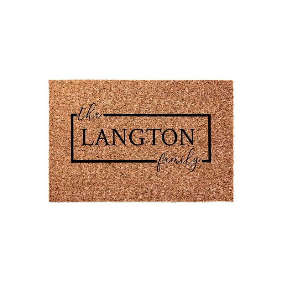 Personalized family name coir doormat featuring a clean rectangular border design with elegant script and bold typography, providing a welcoming entrance decor piece for any home front porch or entryway on a plain white