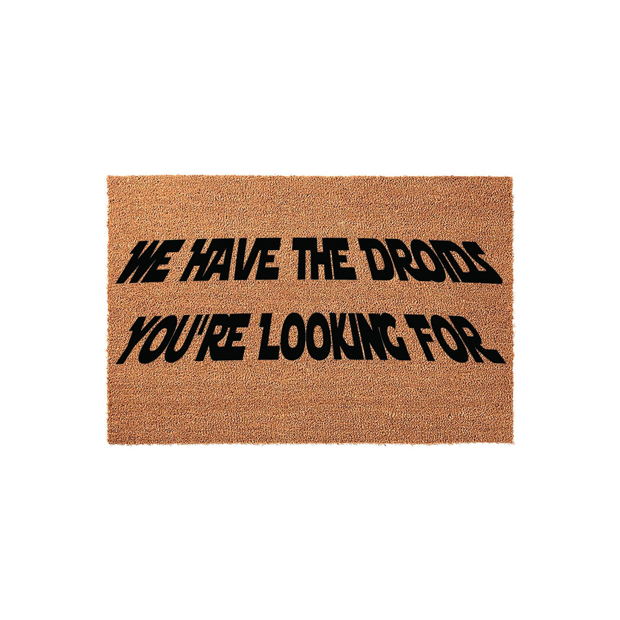Star Wars themed coir doormat featuring the text We Have The Droids You Are Looking For in a bold, black, slanted font against a natural brown fiber background, perfect for a sci-fi fan home entrance or a fun front porch welcome