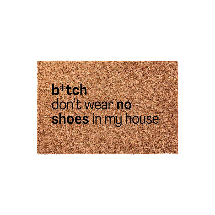 Funny doormat made of natural coir fiber featuring bold black text that reads b*tch don't wear no shoes in my house, providing a humorous and welcoming entryway decor piece for your home on a clean white studio background.