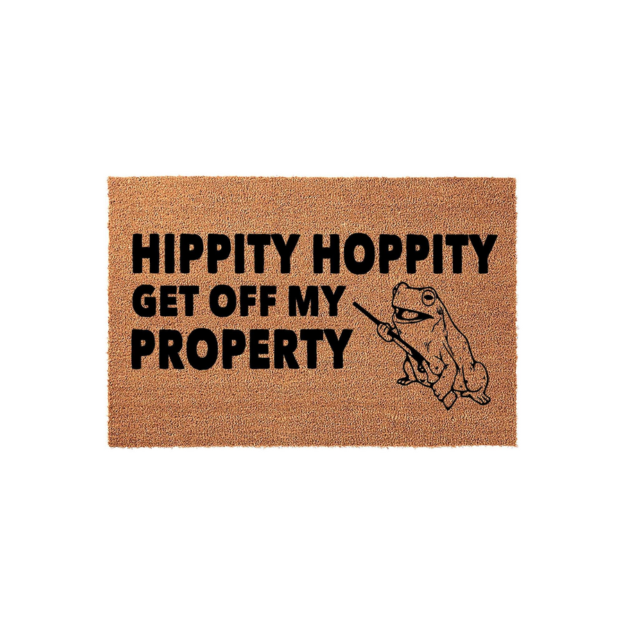 Funny Frog Welcome Doormat featuring a natural coir texture with bold black text that reads Hippity Hoppity Get Off My Property, accompanied by a line-art illustration of a frog holding a stick on a plain white studio background.