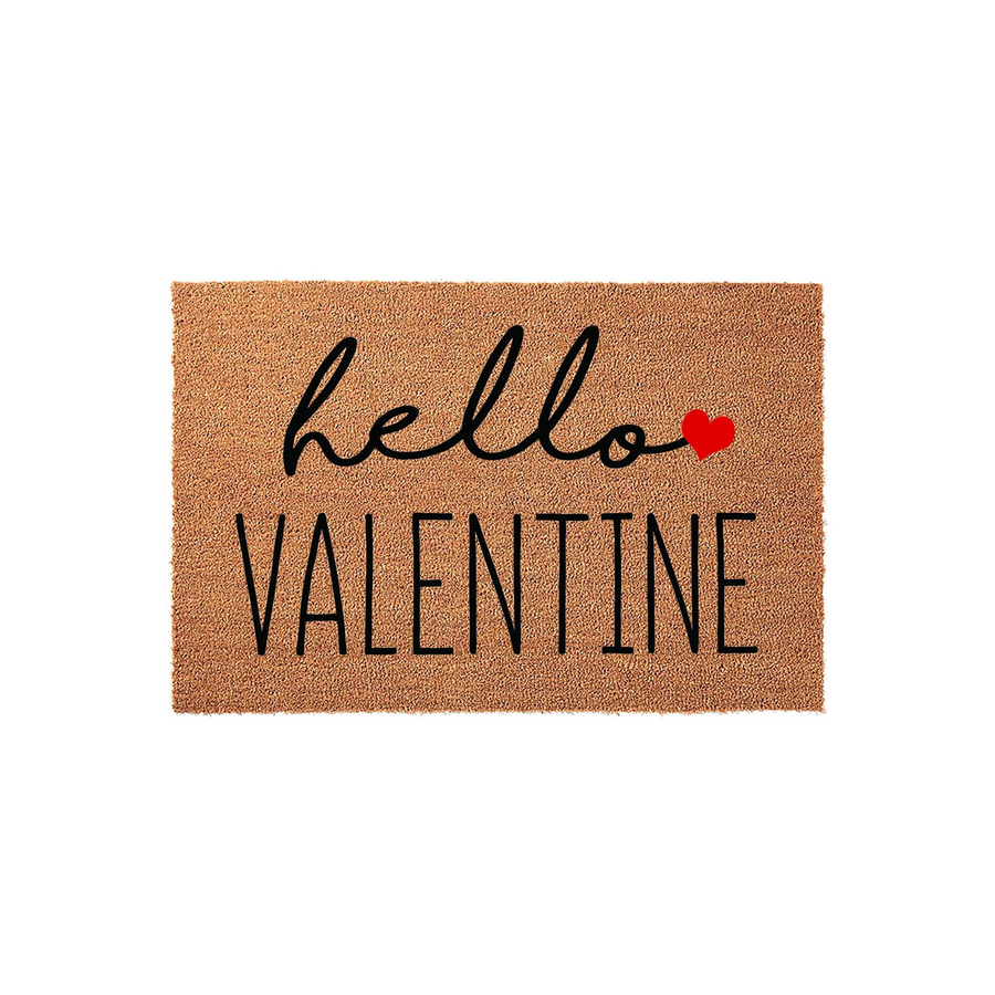 Hello Valentine coir doormat featuring a natural brown fiber texture with black script and block lettering, accented by a small red heart icon, making it a festive front porch decor piece for the February holiday season.