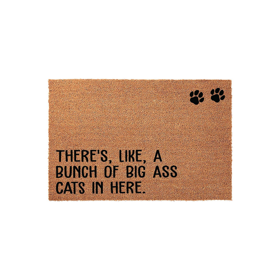 Funny Cat Lover Doormat made of natural coir fiber, featuring the humorous text There's, Like, A Bunch Of Big Ass Cats In Here printed in black ink with two matching paw prints on a plain white background for a clean product view.