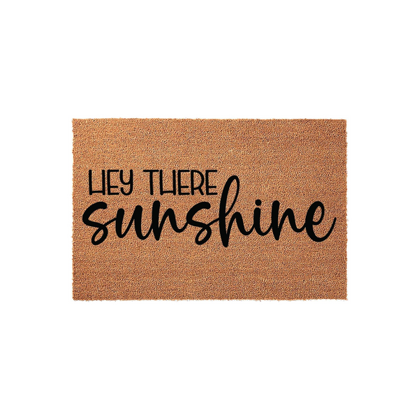 Hey There Sunshine coir doormat featuring a natural brown fiber texture and bold black typography, creating a cheerful and welcoming entrance decor piece for your front porch or home entryway that greets guests with a friendly