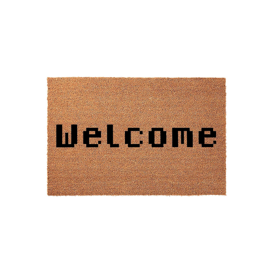 Pixel Art Welcome Doormat featuring a natural brown coir texture with the word Welcome printed in a bold, black, retro-inspired 8-bit video game font centered on the rectangular mat against a clean, solid white studio background.