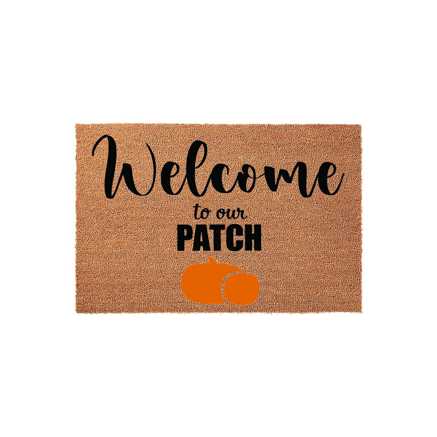 Welcome to our Patch pumpkin coir doormat featuring a natural tan fiber texture with black script lettering and two bright orange pumpkins printed at the bottom, creating a festive fall entryway decor piece for your front porch.