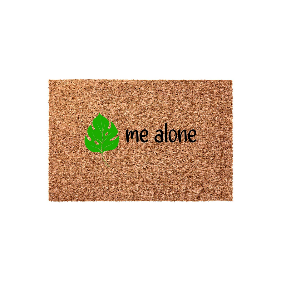 Monstera Leaf Doormat with the text me alone, featuring a natural brown coir texture and a bright green tropical plant illustration on the left side, creating a humorous and welcoming entryway decor piece for any home or