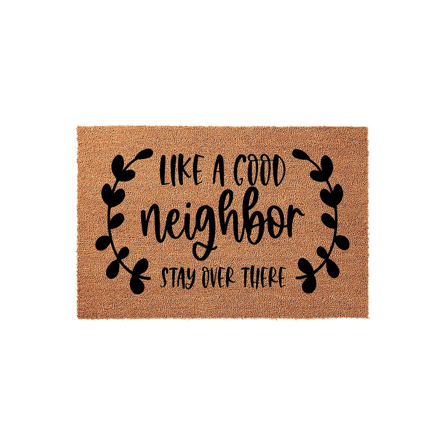 Funny Like a Good Neighbor Stay Over There coir doormat featuring bold black typography and decorative leaf accents on a natural brown fiber background, creating a humorous welcome mat for your front porch or entryway decor.