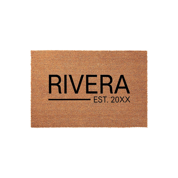 Personalized family name coir doormat featuring a natural brown fiber texture with bold black text that displays a custom last name and an established year, creating a welcoming entrance for any home on a clean white studio
