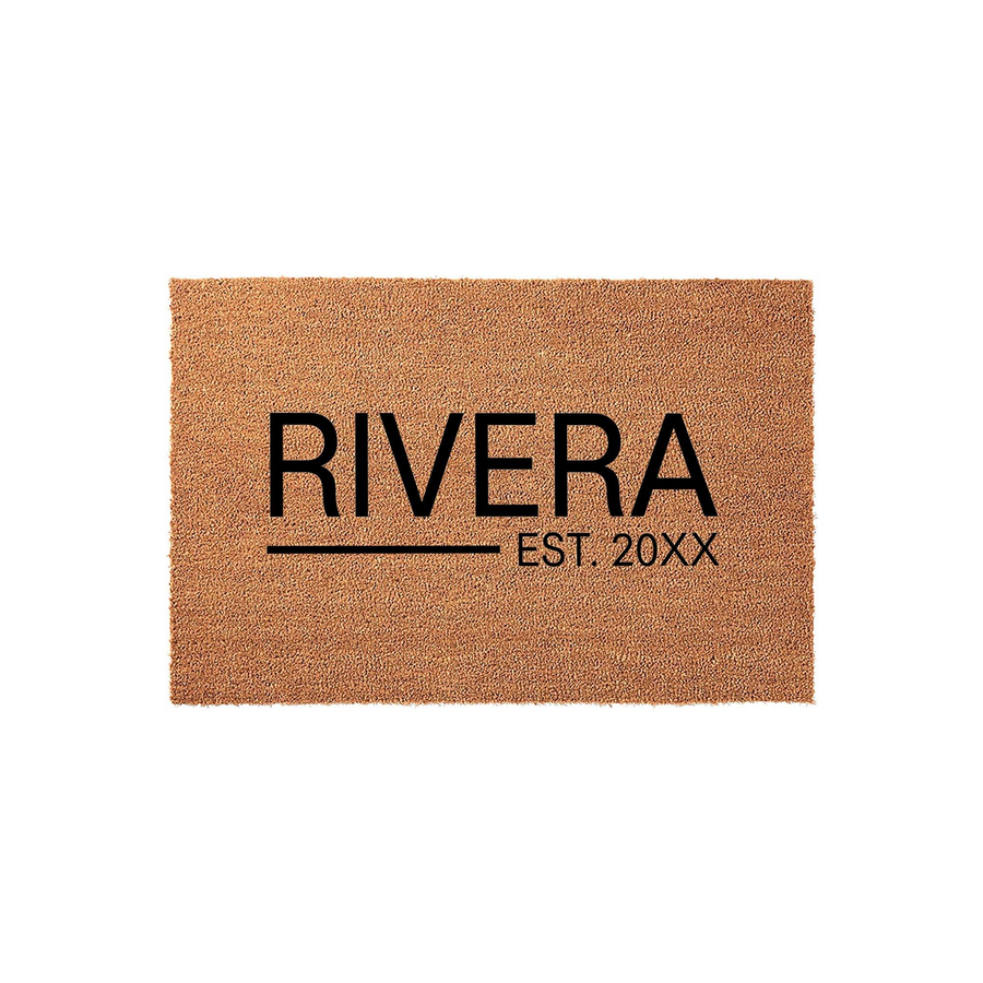 Personalized family name coir doormat featuring a natural brown fiber texture with bold black text that displays a custom last name and an established year, creating a welcoming entrance for any home on a clean white studio