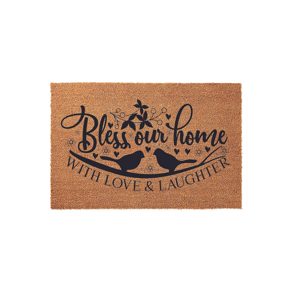 Bless Our Home Coir Doormat featuring a charming design of two birds perched on a branch with floral accents and hearts, printed in black ink on a natural brown textured fiber surface for a welcoming front porch entryway decor.