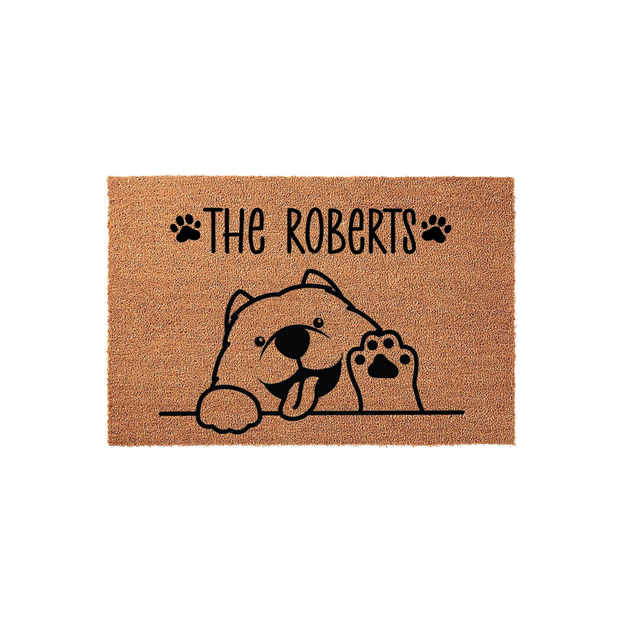 Personalized Dog Welcome Doormat featuring a cute illustrated puppy waving hello, printed on a natural coir fiber mat with a custom family name and paw print accents for a charming entryway decor piece that greets all your house
