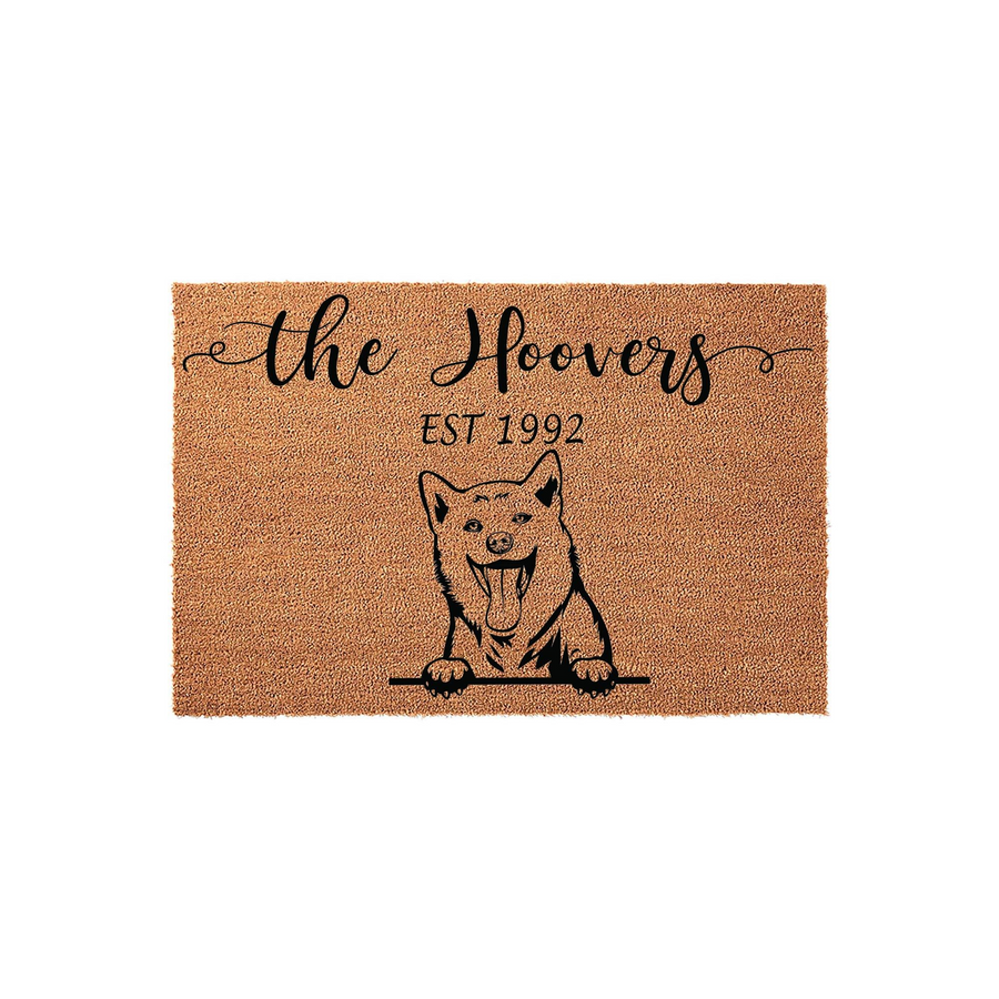 Personalized Shiba Inu doormat featuring a cute dog illustration and custom family name text on a natural coir fiber background, creating a welcoming entrance for any dog lover home with a durable and rustic outdoor floor mat