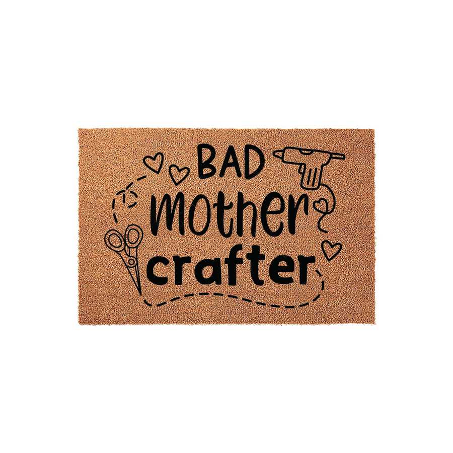 Bad Mother Crafter coir doormat featuring a natural tan fiber texture with black printed text, scissors, and a hot glue gun icon, creating a fun and humorous entryway decor piece for any creative mom who loves DIY craft projects.