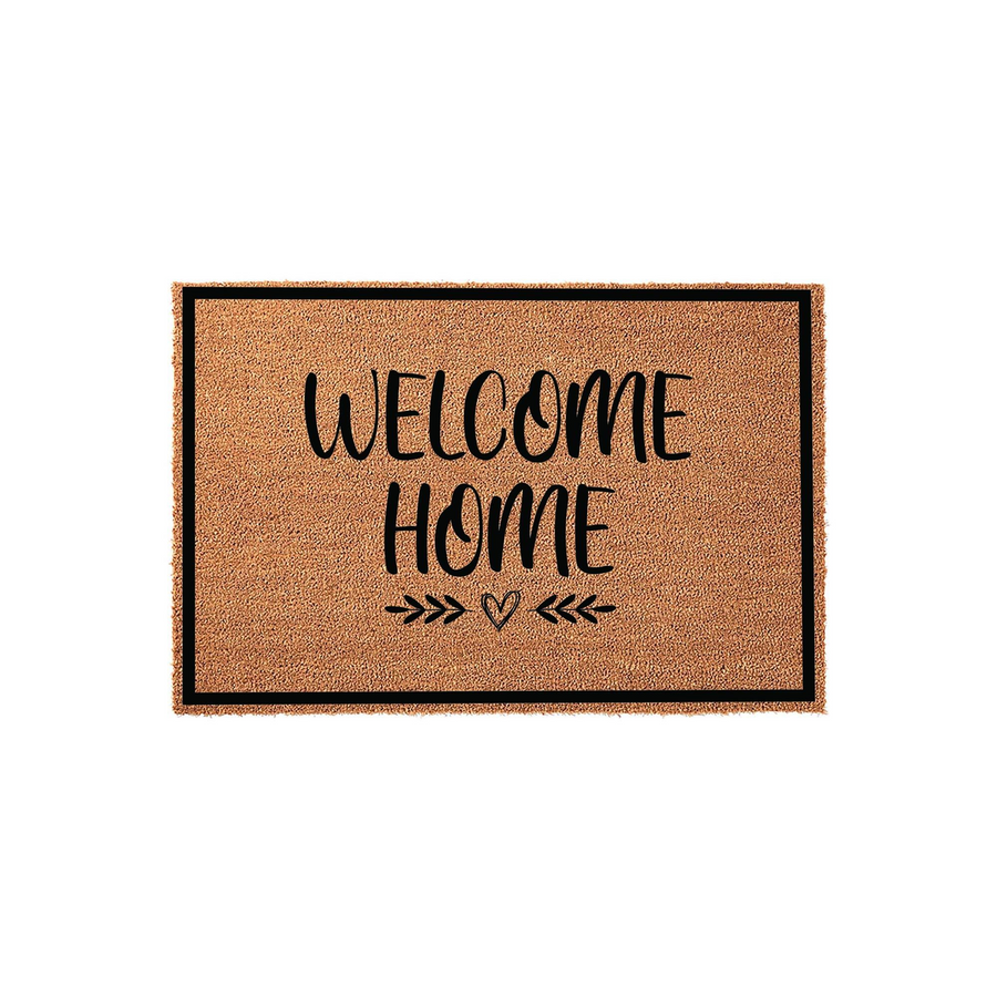 Welcome Home coir doormat featuring a natural tan fiber texture with a black border and elegant black script lettering, accented by a small heart and arrow design centered at the bottom for a charming front porch entryway