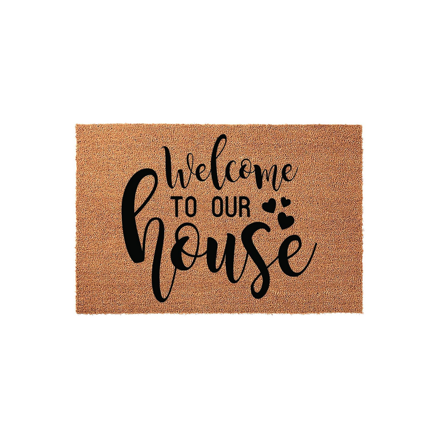 Welcome to Our House coir doormat featuring a natural tan fiber texture and bold black script lettering, creating a warm and inviting entryway accent for your front porch or home entrance on a clean white background.