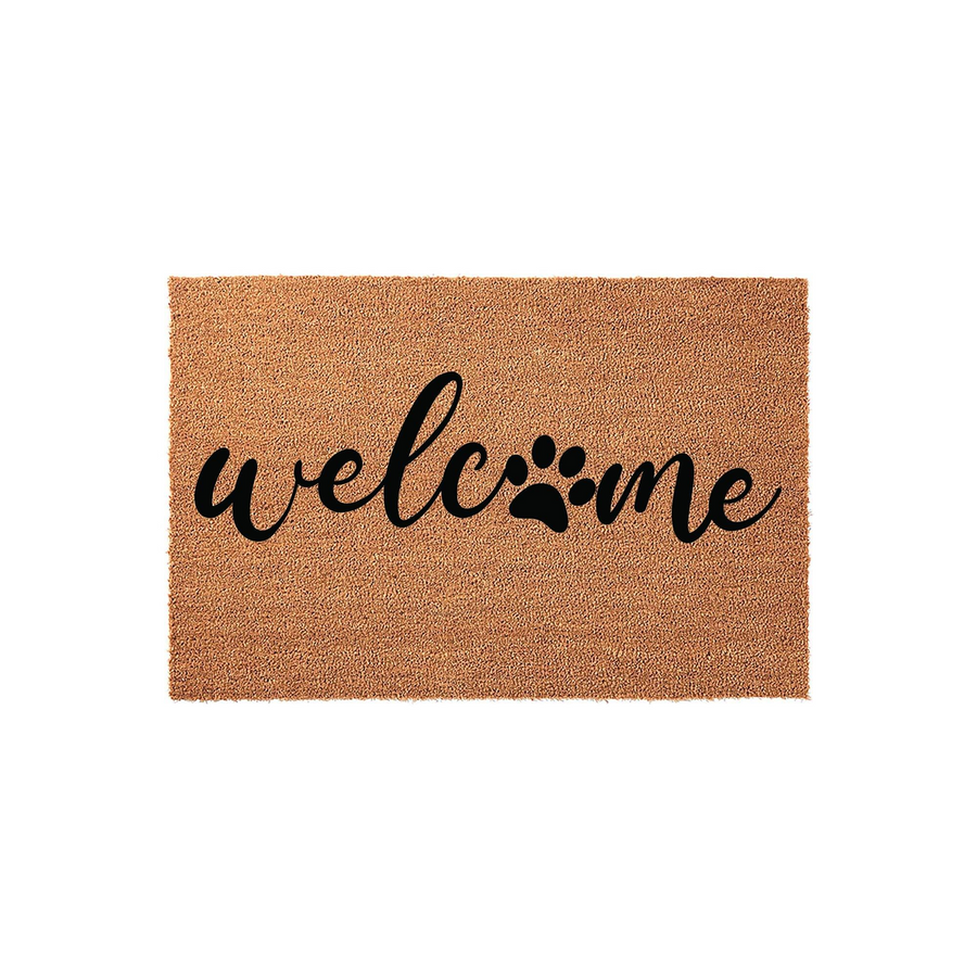 Pet lover welcome doormat made of natural coir fiber, featuring the word welcome in black script lettering where the letter o is replaced by a cute paw print design, set against a clean white background for a modern entryway look.
