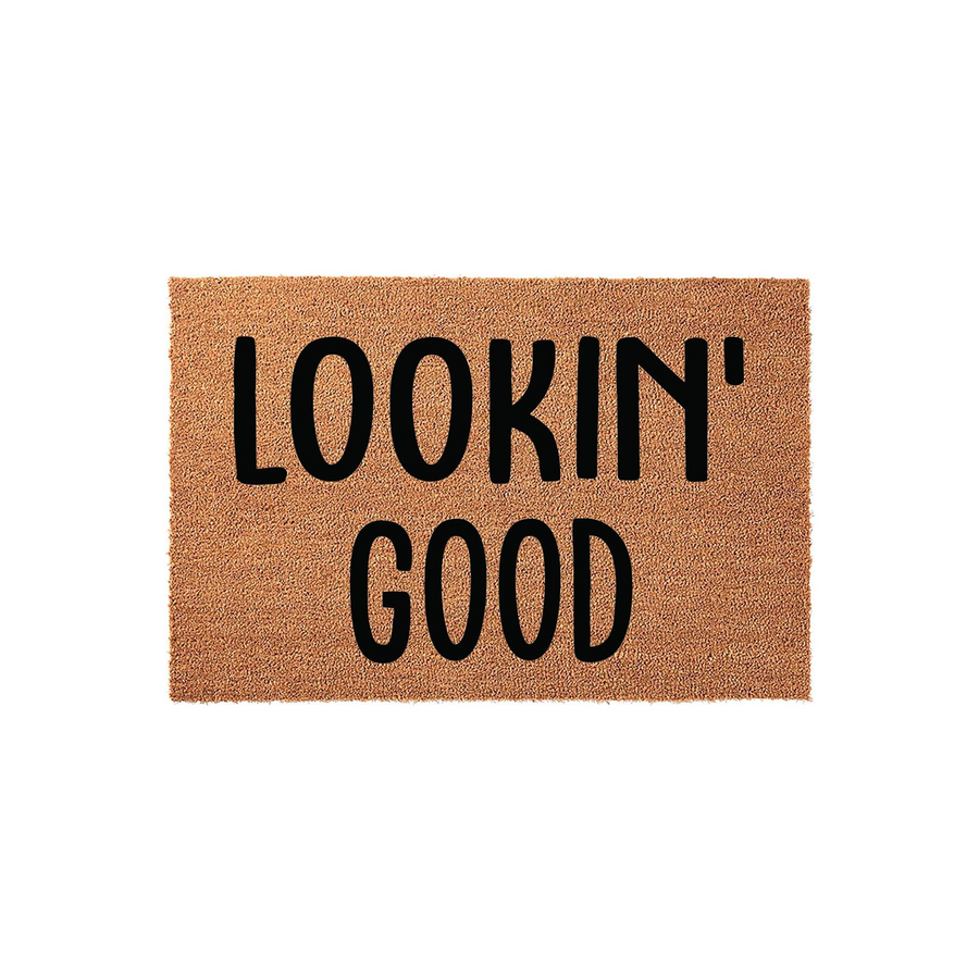 Lookin' Good coir doormat featuring a natural tan fiber texture and bold black lettering, providing a fun and welcoming entrance decor piece for your front porch or entryway that greets guests with a stylish and modern aesthetic.