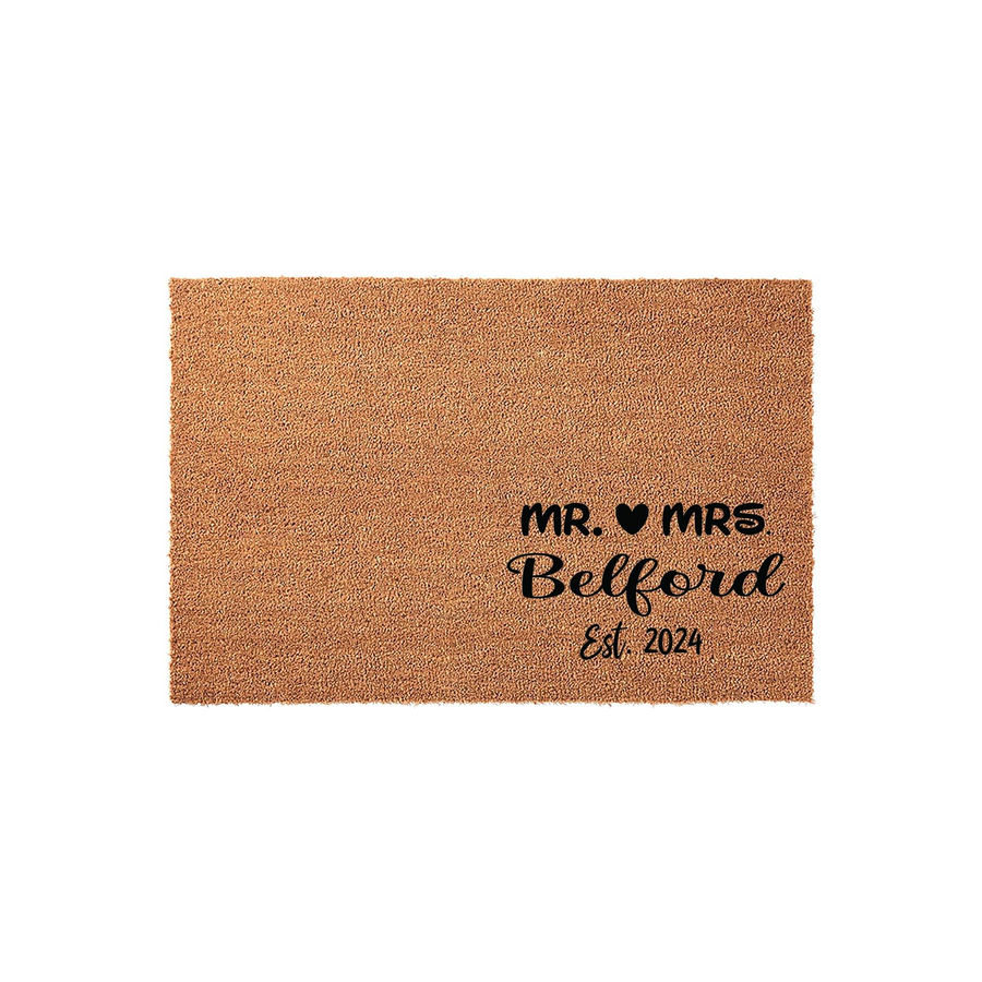 Personalized Mr. and Mrs. Wedding Doormat featuring a natural coir texture with black printed text that includes a heart icon, a family name, and an established year, set against a clean white background for a modern home